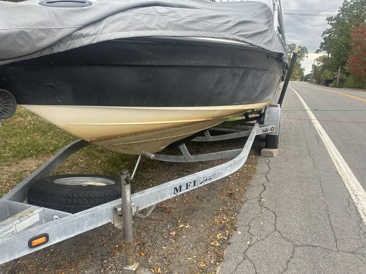 Boat hull before detailing, with the lower hull streaked and stained along the waterline