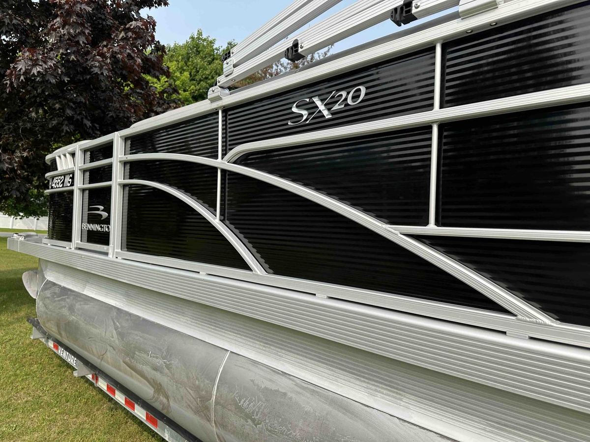A freshly detailed Bennington SX20 pontoon boat with polished aluminum rails
