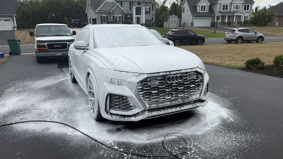 An Audi RS Q8 covered in thick detailing foam on a residential driveway near Rochester NY