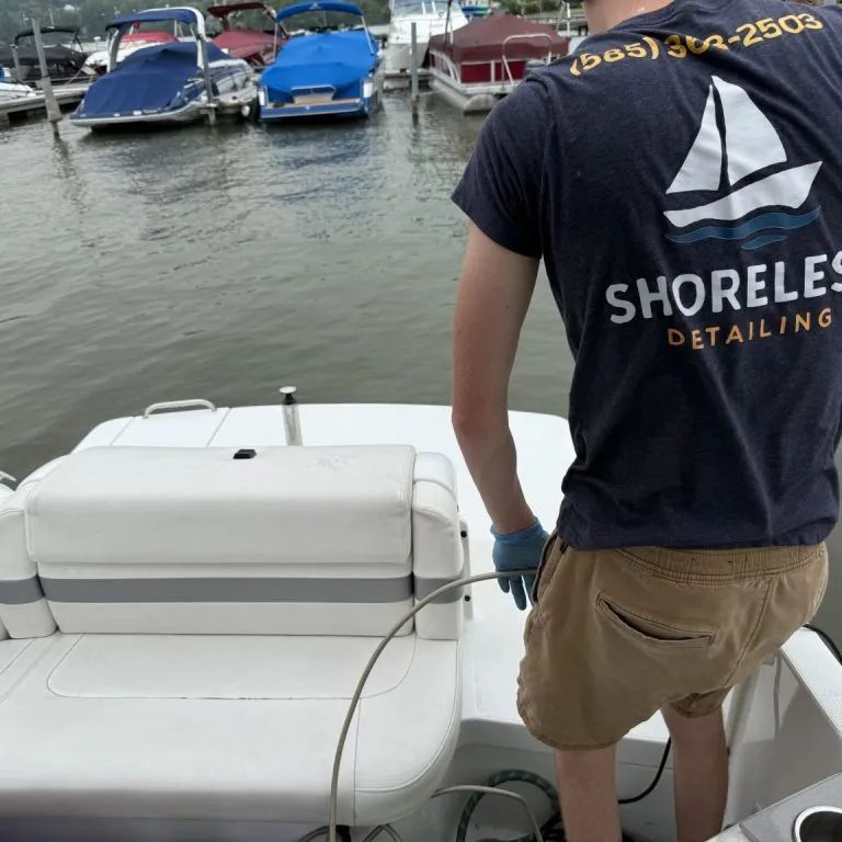 Shoreless Detailing technician cleaning boat upholstery at a Finger Lakes marina