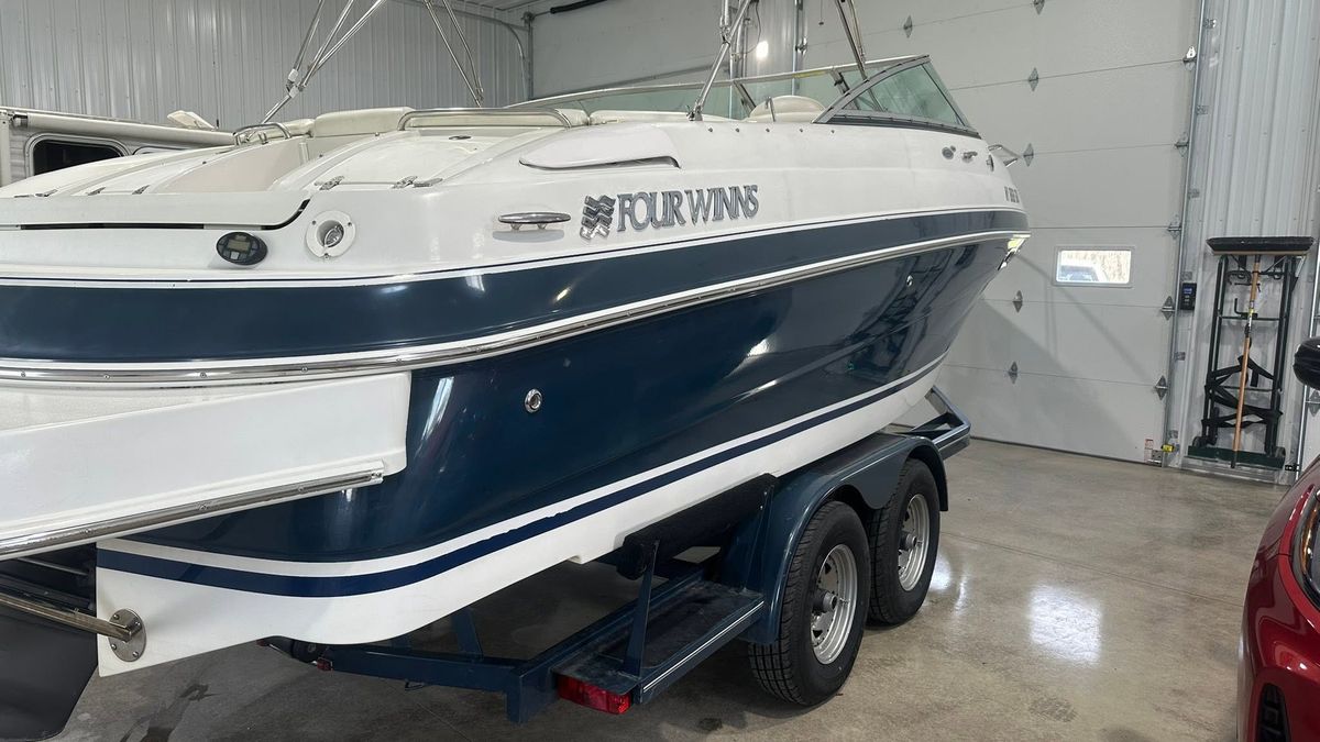 A Four Winns bowrider on its trailer in the shop, ready for detailing